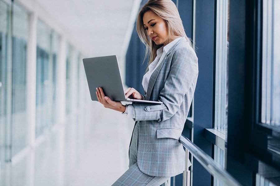 A women standing with a laptop