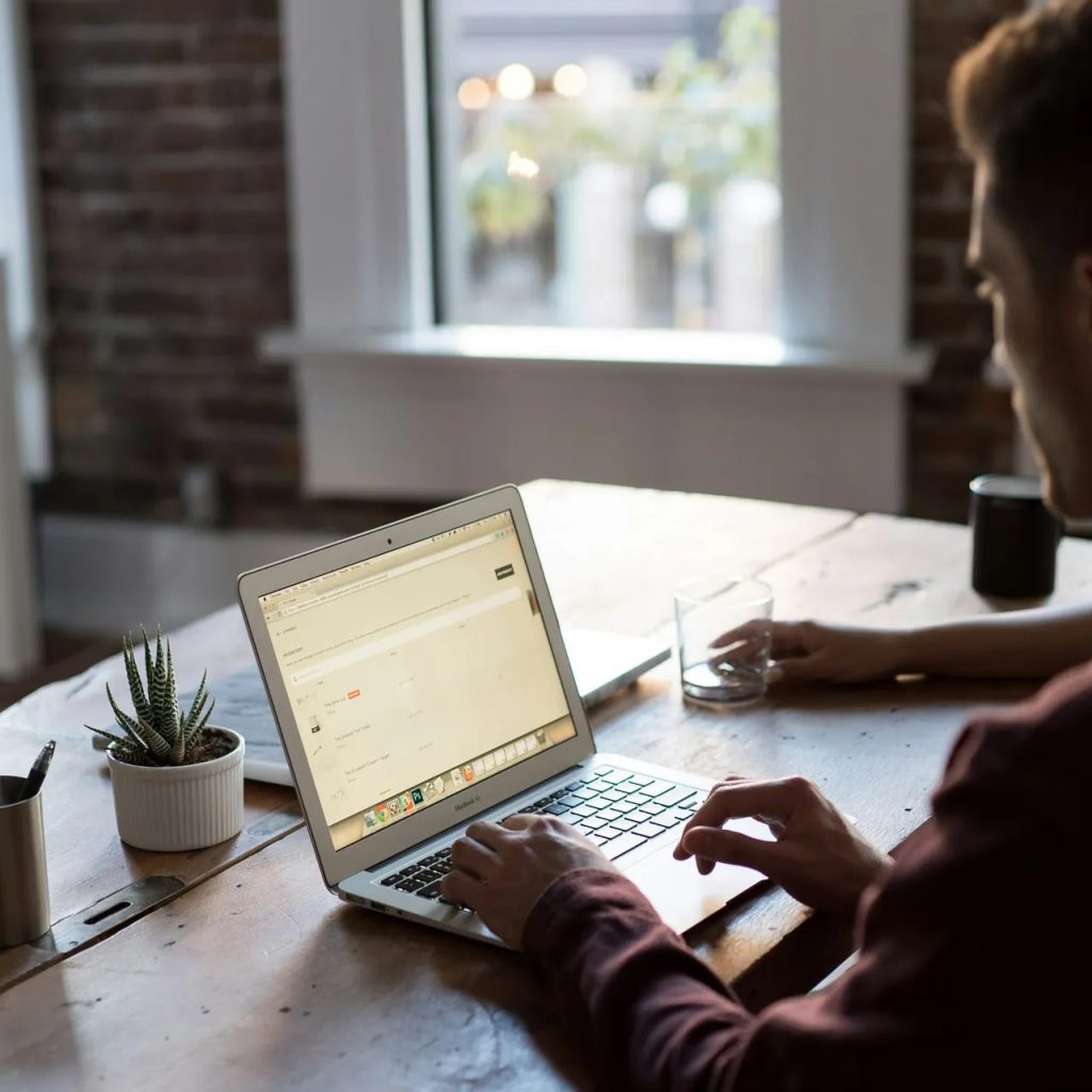 An image of a person working on laptop