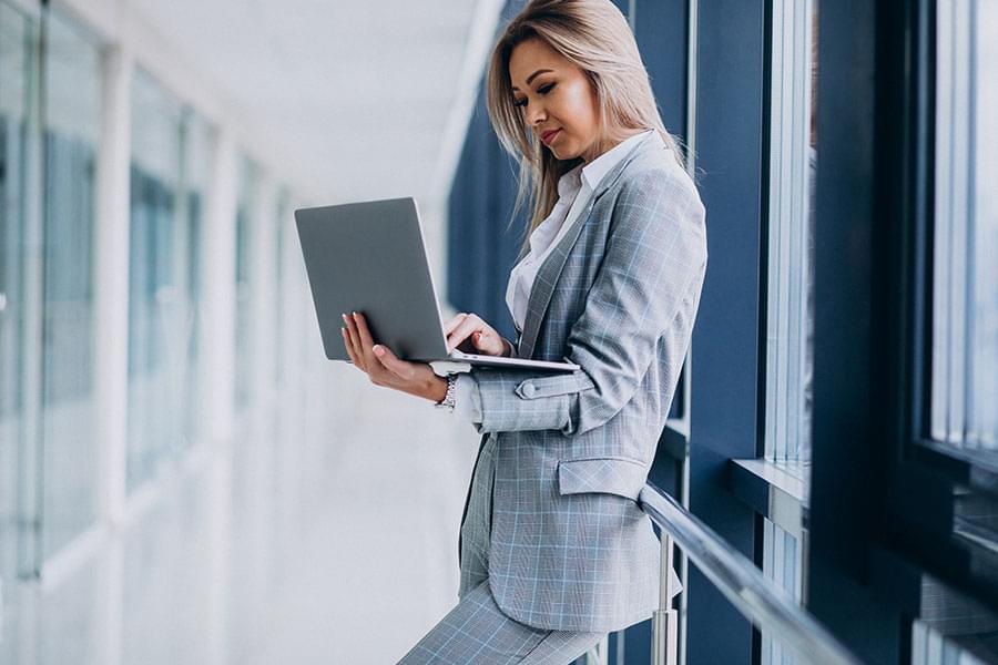 A women standing with a laptop