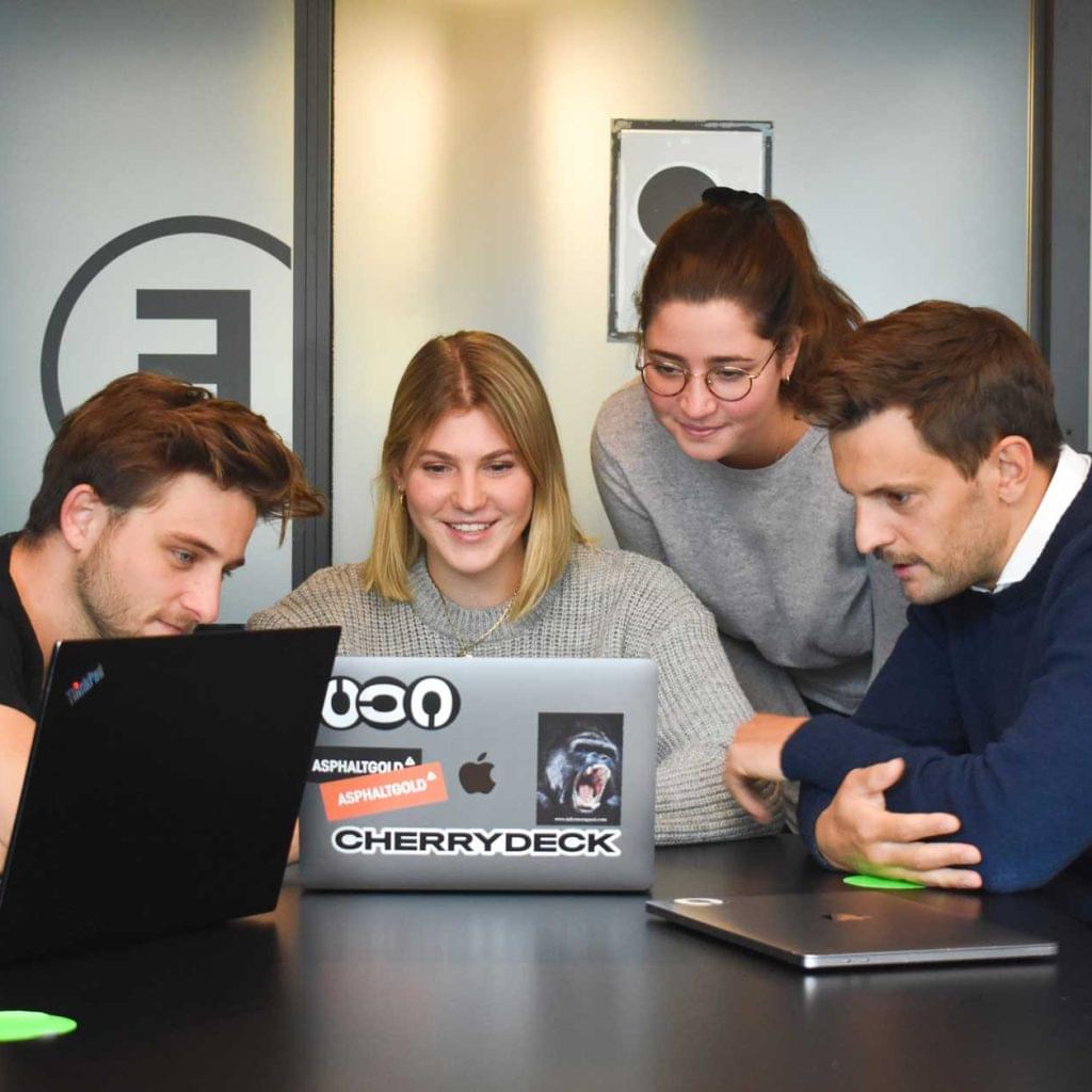 4 team members working on their laptops